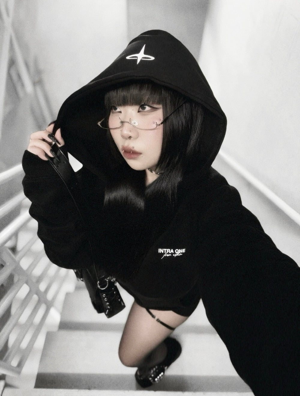 xxiaobaituu wearing INTRA ONE's signature hoodie, in a dark monochromatic aesthetic