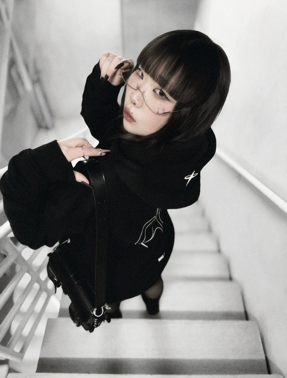 xxiaobaituu wearing INTRA ONE's signature hoodie, in a dark monochromatic aesthetic