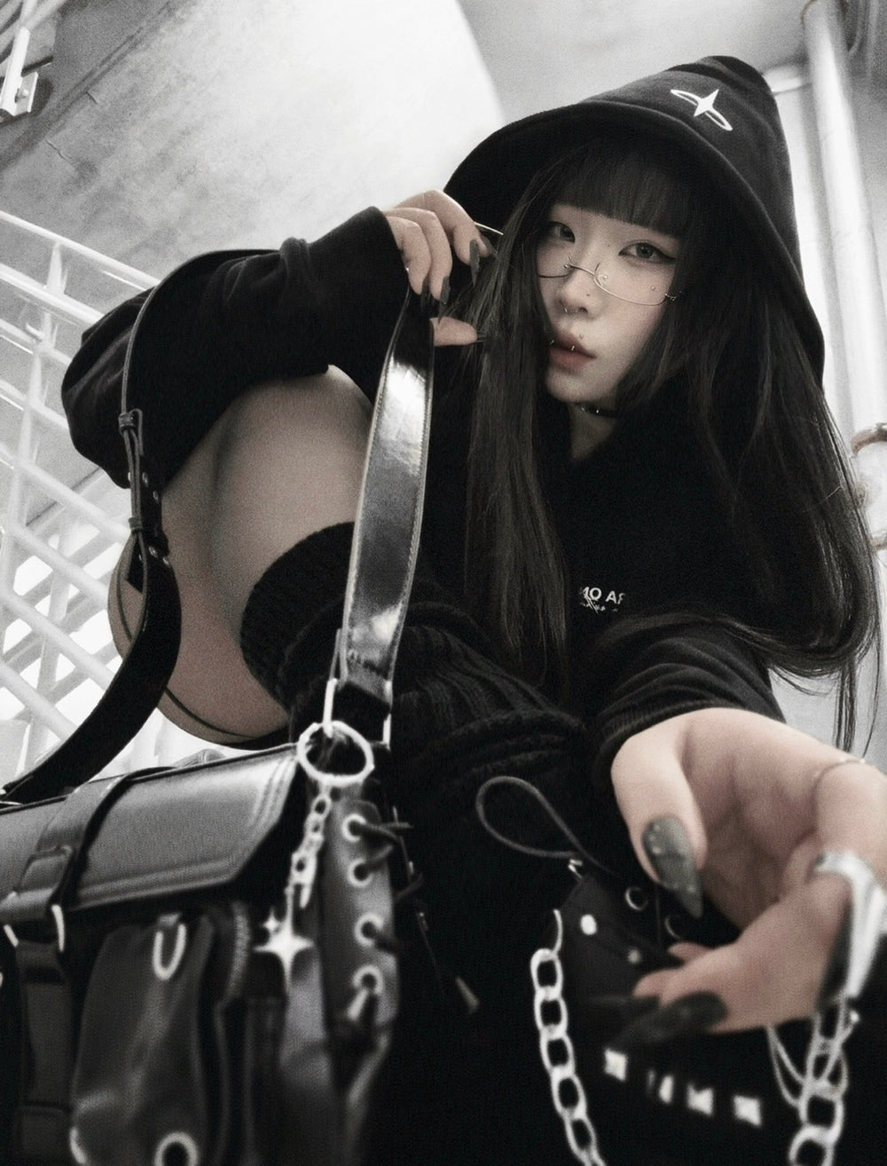 xxiaobaituu wearing INTRA ONE's signature hoodie, in a dark monochromatic aesthetic