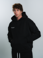 male model wearing INTRA ONE's signature hoodie in black