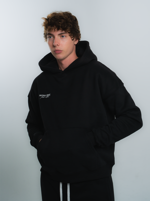 male model wearing INTRA ONE's signature hoodie in black