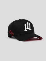 INTRA ONE's black 5 panel cap with 111 angel number logo symbol on it, with 2 small embroidered hearts and a red underbrim