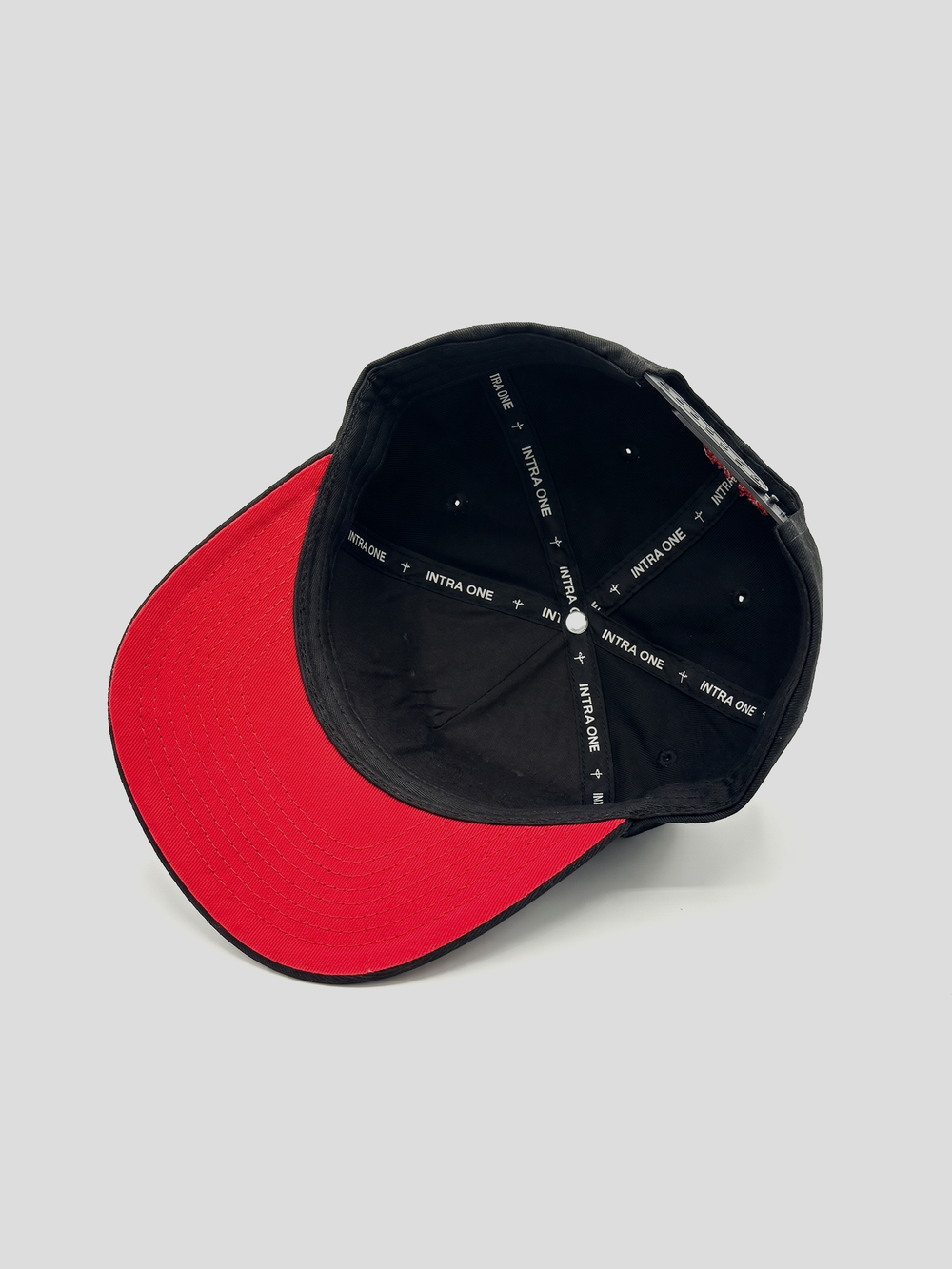 INTRA ONE's black 111 logo 5 panel cap with a red underbrim