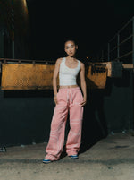 Female model wearing INTRA ONE signature sweats in pink for a streetwear fashion shoot