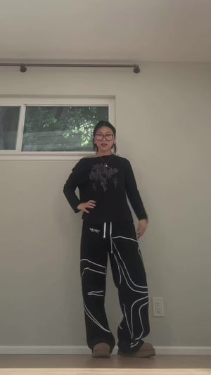 linasunmee dancing to Dracula, wearing INTRA ONE's signature sweats in black